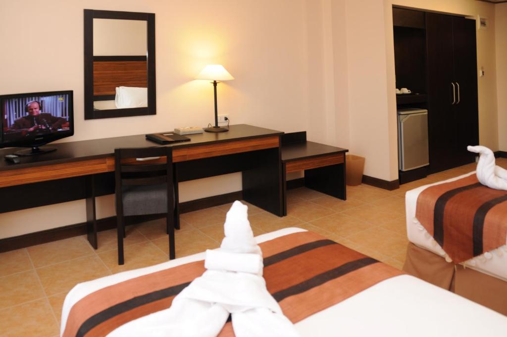 Postel nebo postele na pokoji v ubytování Hotel Tropika