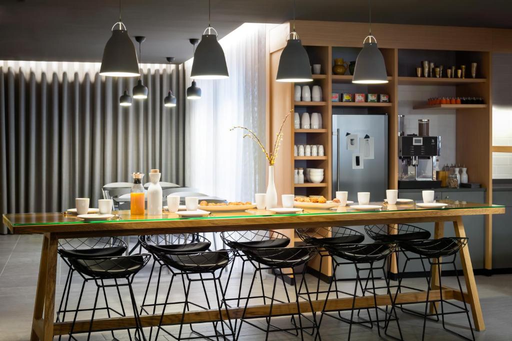 a kitchen filled with tables and chairs at Okko Hotels Nantes Château in Nantes