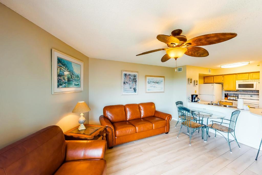 a living room with a couch and a ceiling fan at Ocean Point #2210 in Tavernier