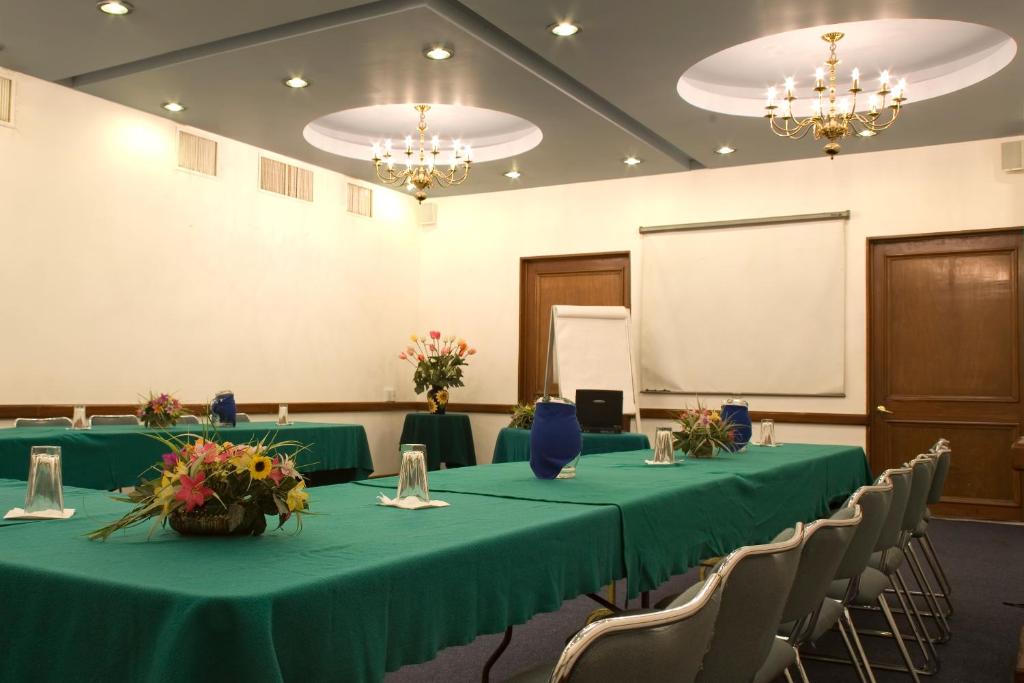 A larger formal conference room prepared with banquet tables and chairs.