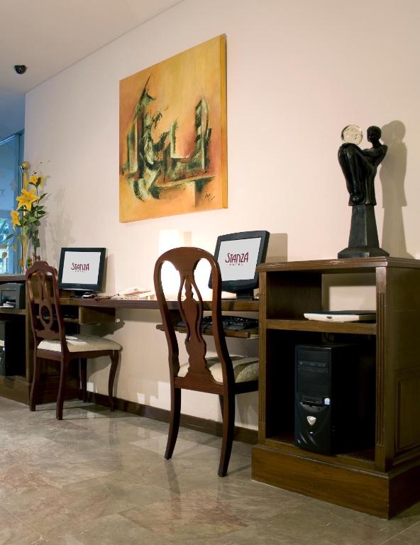 A compact business area with two desktop computers and a shared desk.