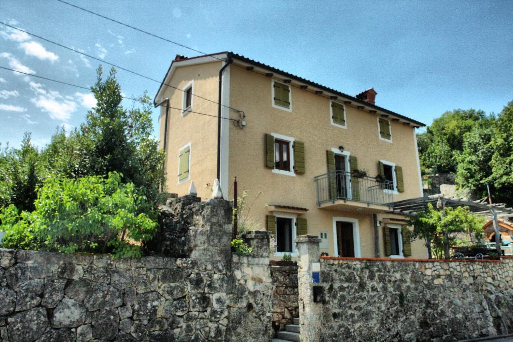 una grande casa dietro un muro di pietra di Apartment with soul a Mošćenička Draga