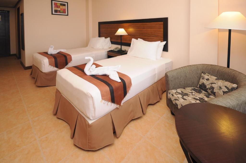 Postel nebo postele na pokoji v ubytování Hotel Tropika