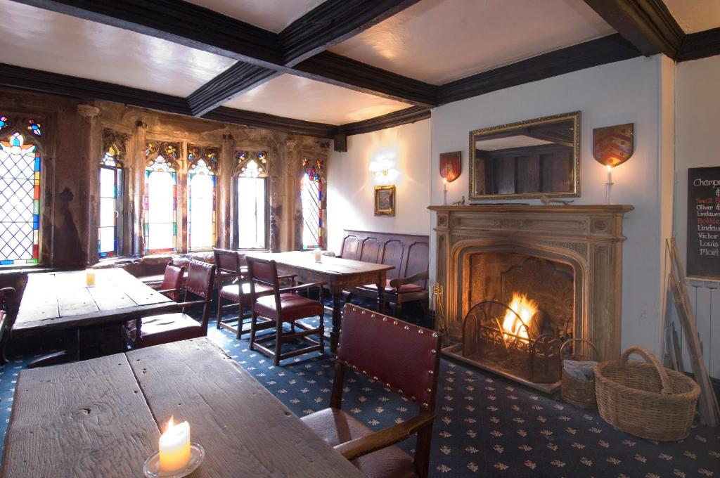 
a living room filled with furniture and a fire place at George & Pilgrims Hotel in Glastonbury
