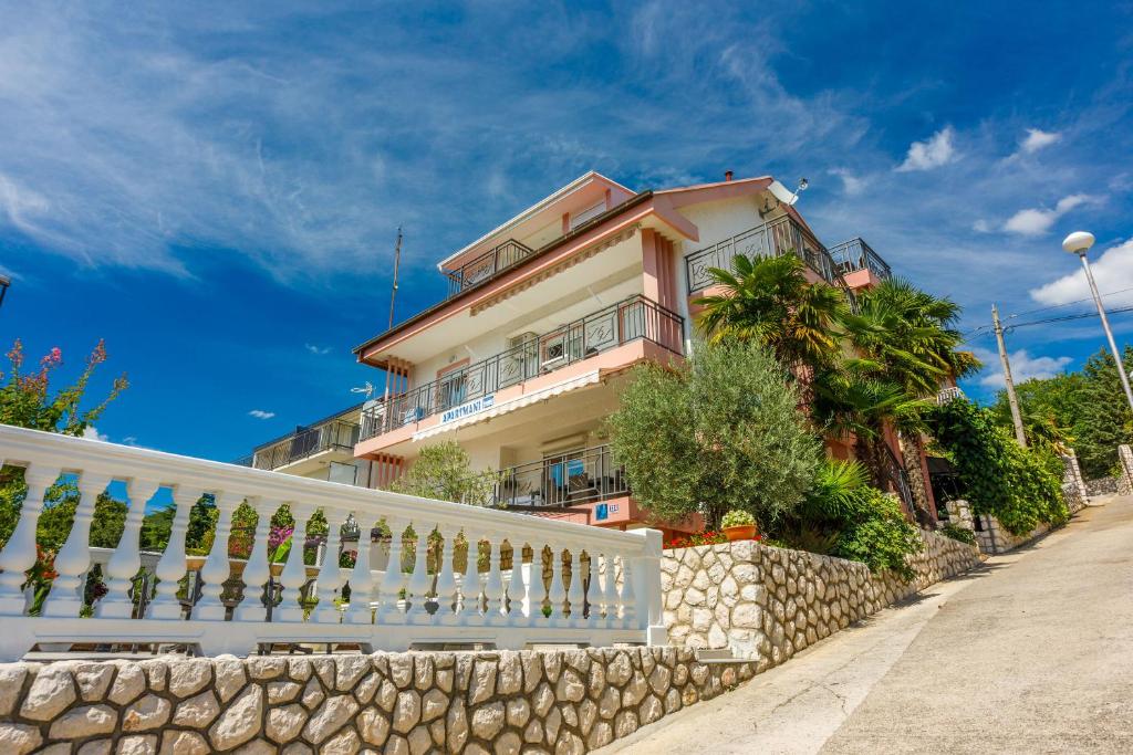 a house with a white fence in front of it at Apartments Marijana in Crikvenica