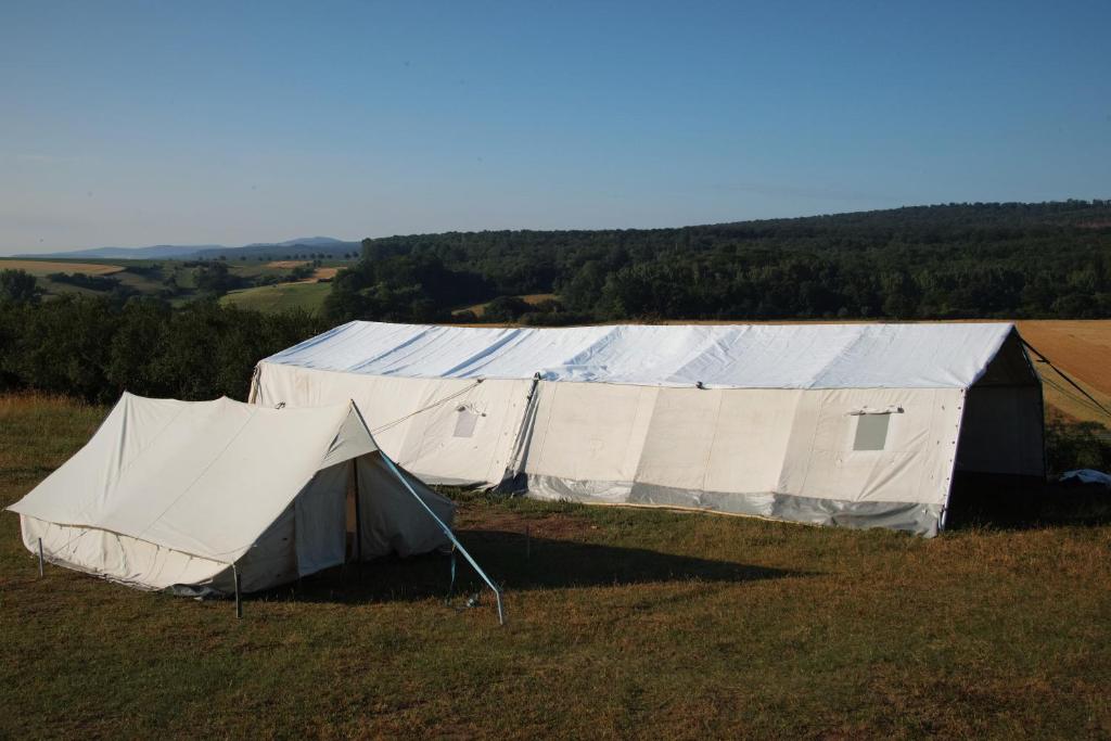 two tents sitting on top of a field at Safaritent Heidschnuckenhof das Camp in Niedermeiser