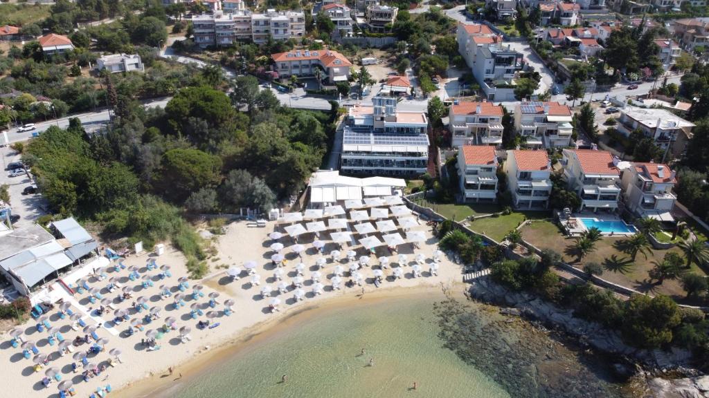 an aerial view of a beach with umbrellas and chairs at Porto Palio Beach Hotel in Paleo Tsifliki