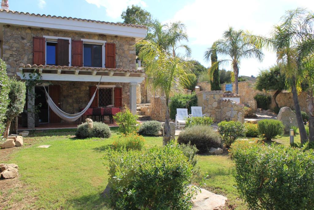 a house with a hammock in a yard at Villa Antonella in Villasimius