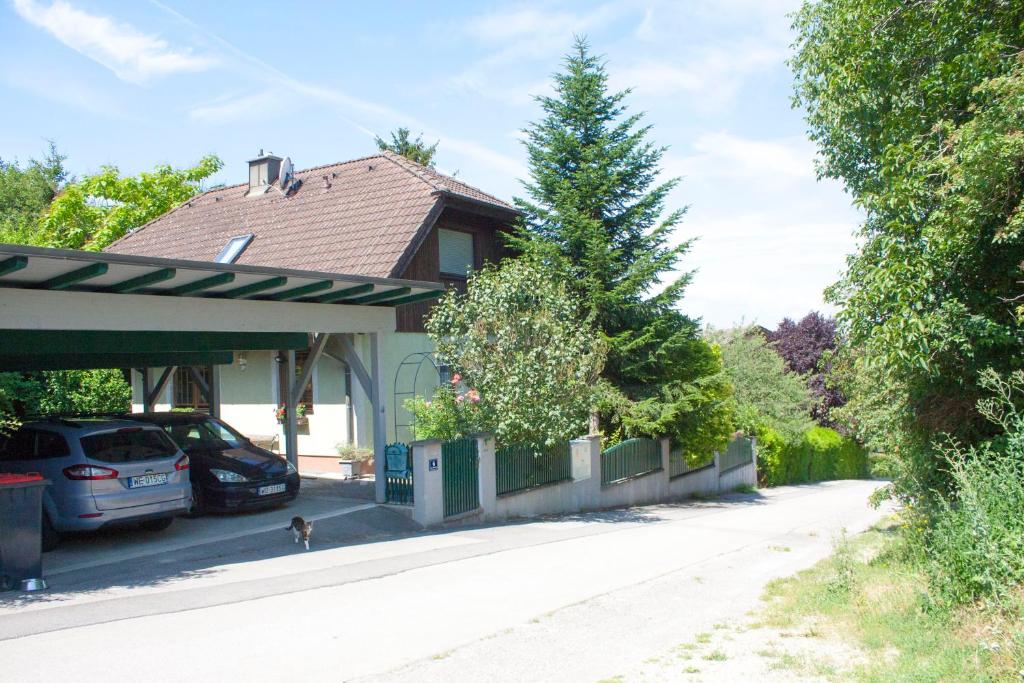 a house with a car parked in the driveway at B&B Family Basement Apartment, Breakfast, Free Parking, 5km from Tulln in Chorherrn