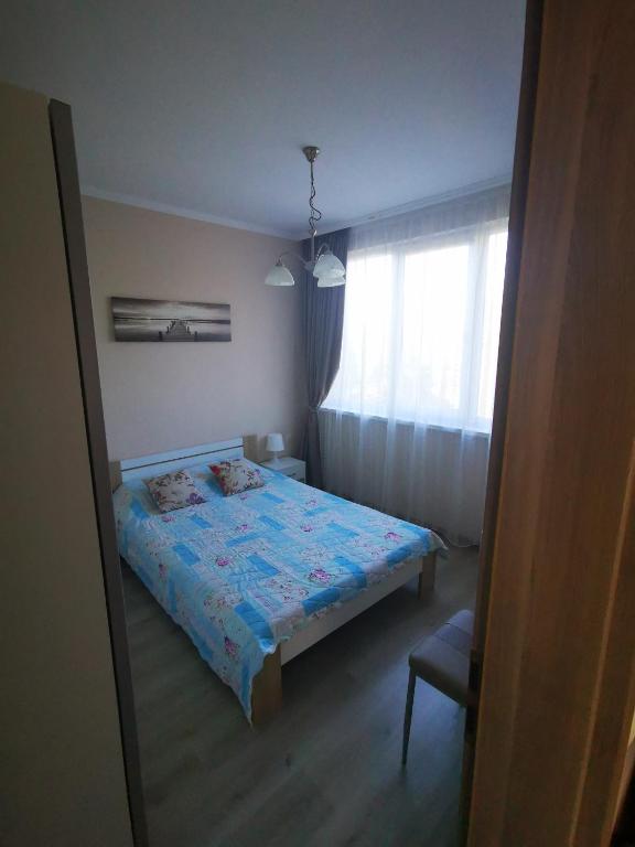 A bed or beds in a room at Уютные Апартаменты VIP PARK