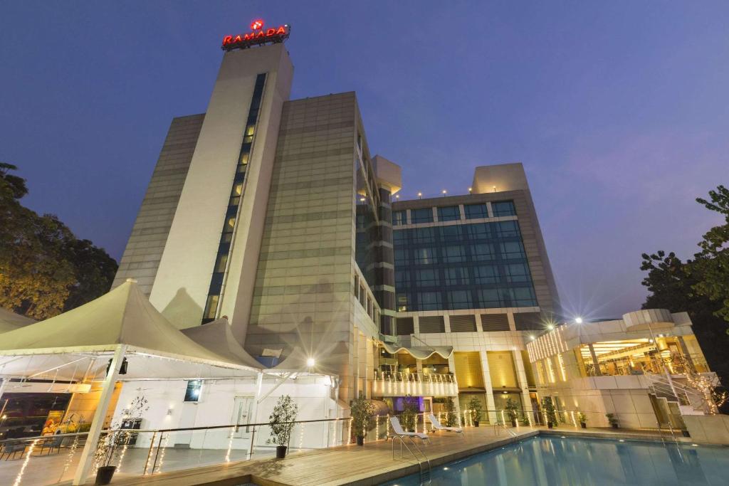 a hotel with a pool in front of a building at Ramada by Wyndham Navi Mumbai in Navi Mumbai