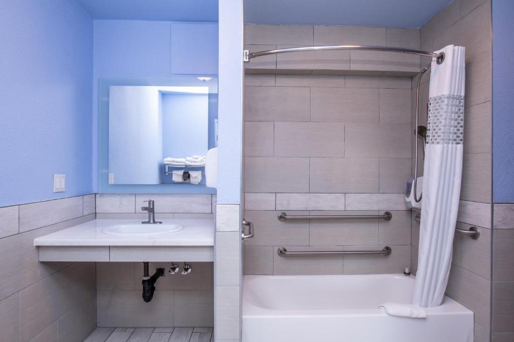 a bathroom with a sink and a shower at Aqua Breeze Inn in Santa Cruz