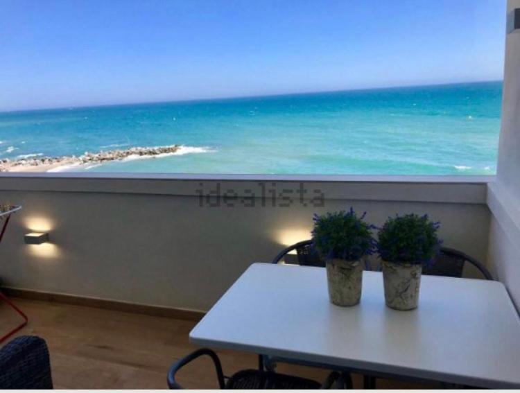 - une table avec deux plantes sur laquelle elle offre une vue sur l'océan dans l'établissement La Perla Playa apartamento a estrenar, à Benalmádena