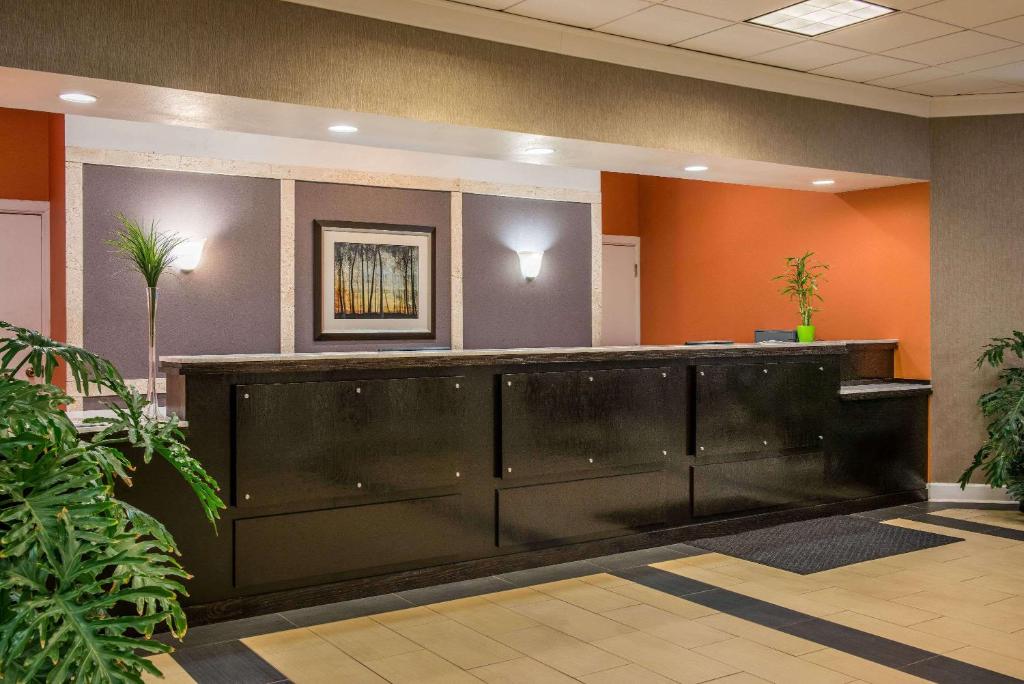 an office lobby with a large black reception desk at Super 8 by Wyndham Little Rock/Otter Creek in Little Rock