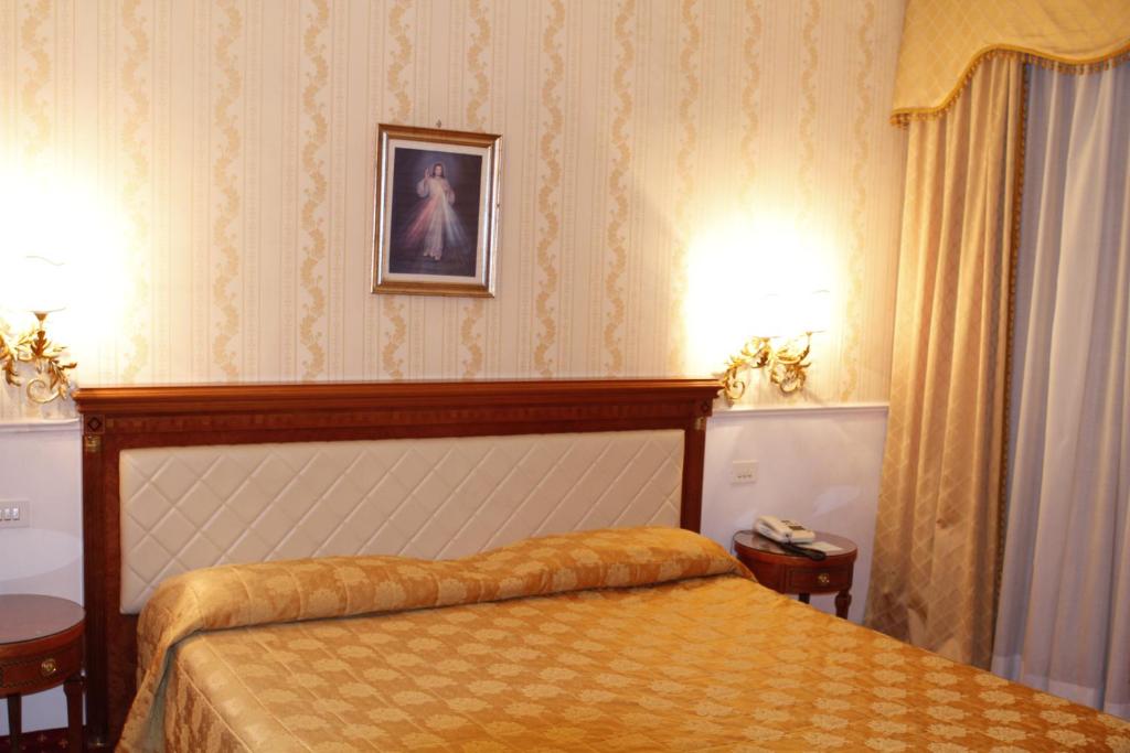 Postel nebo postele na pokoji v ubytování Hotel Genio