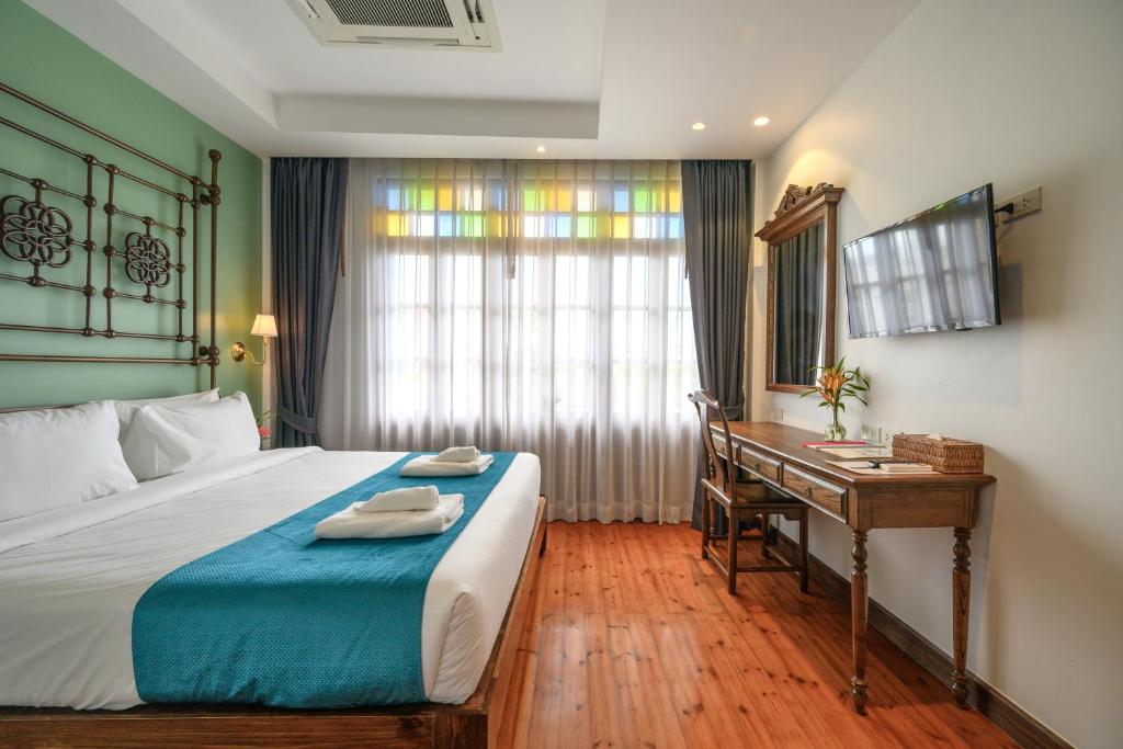 Postel nebo postele na pokoji v ubytování WOO Gallery & Boutique hotel