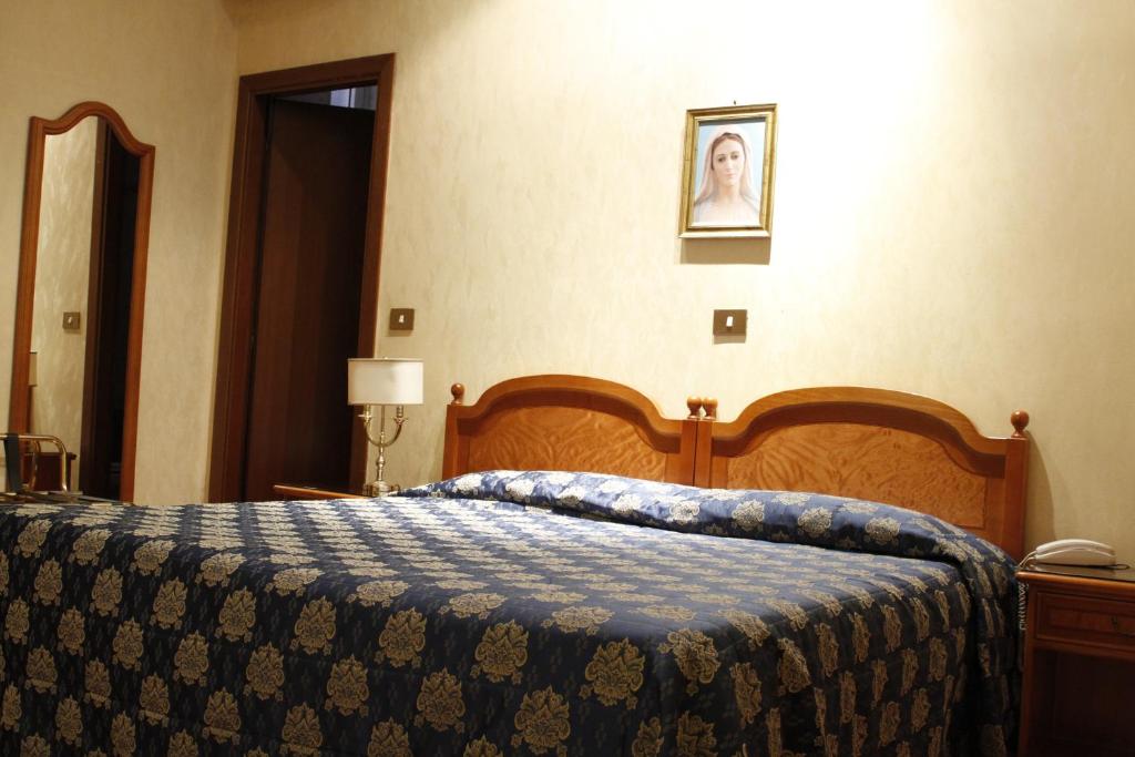 Postel nebo postele na pokoji v ubytování Hotel Genio