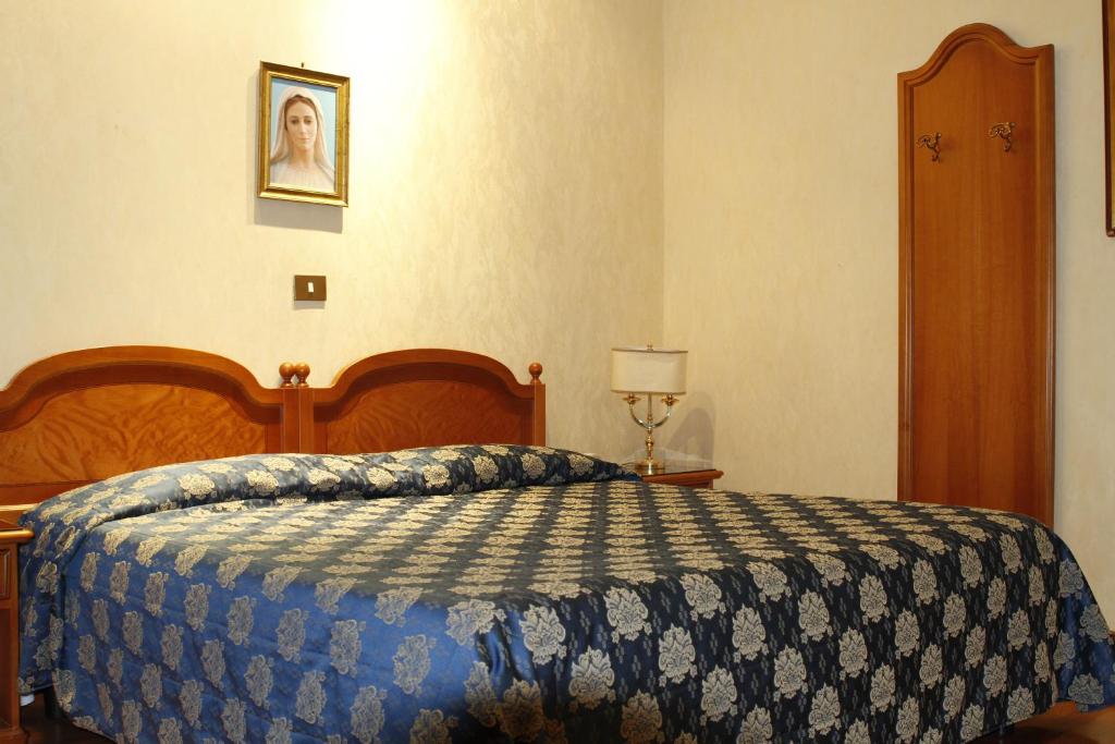 Postel nebo postele na pokoji v ubytování Hotel Genio