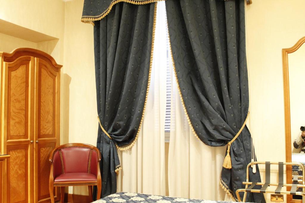 Postel nebo postele na pokoji v ubytování Hotel Genio