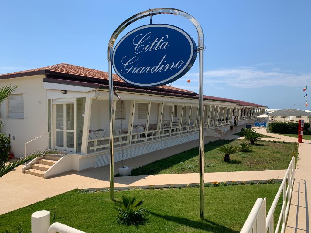 a sign for a hotel in front of a building at Stabilimento Balneare Città Giardino - Casa Vacanza in Viareggio
