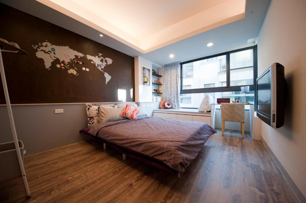 ein Schlafzimmer mit einer großen Weltkarte an der Wand in der Unterkunft Ken's Joy Inn in Kaohsiung