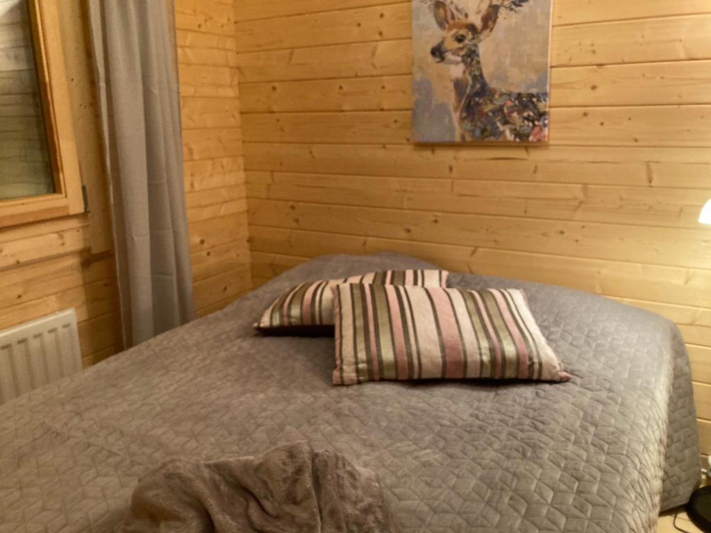 a bedroom with a bed with a pillow on it at Asplunda Gård,Kolmården, stuga nr 4 in Kolmården