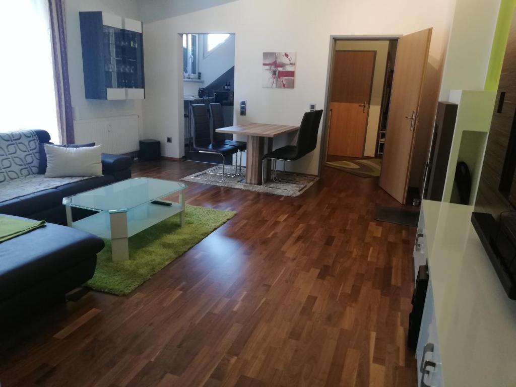 ein Wohnzimmer mit einem Sofa und einem Tisch in der Unterkunft Klagenfurt`s Loft in Klagenfurt am Wörthersee