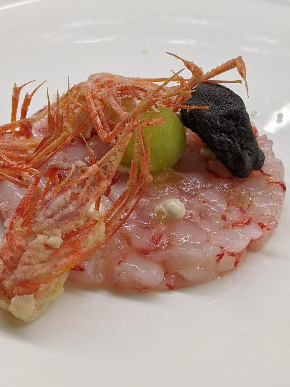 a plate of food with shrimp and a lime at Hotel Miramare & Spa in Sestri Levante