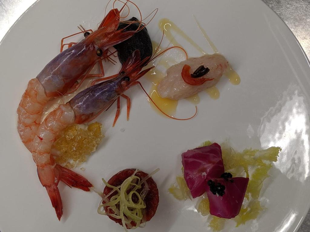 a plate of food with shrimp and vegetables on it at Hotel Miramare & Spa in Sestri Levante