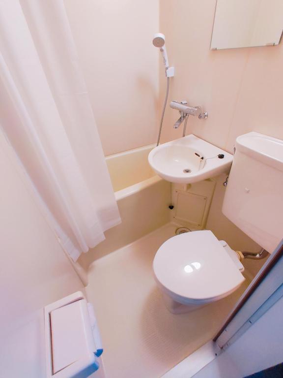 さいたま市にあるMEME Inn与野本町駅前のトイレと洗面台のある小さなバスルーム