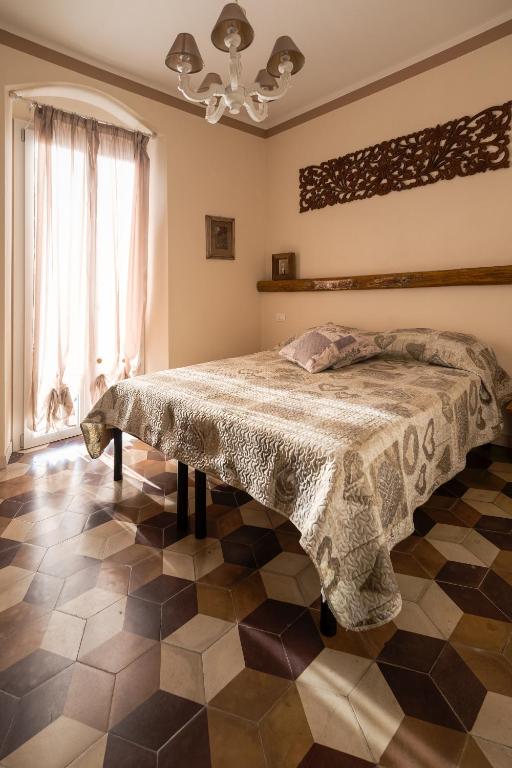 a bedroom with a bed and a checkered floor at La corte dei tre in Torre del Lago Puccini
