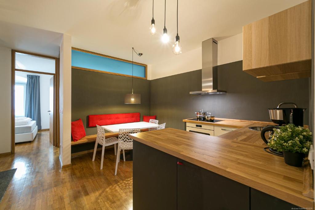 a kitchen with a table and a dining room at Laubenapartment in Merano