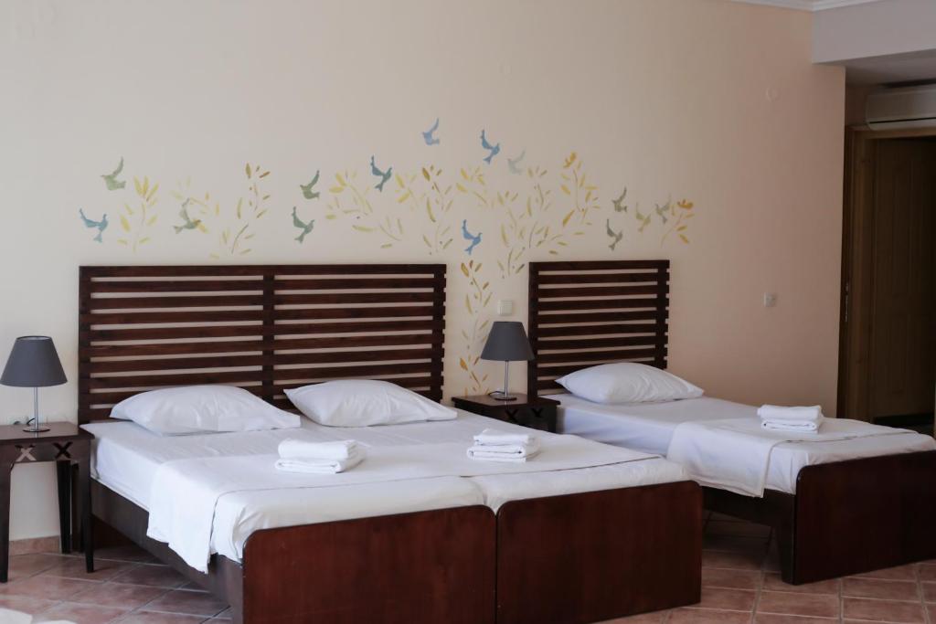 Posteľ alebo postele v izbe v ubytovaní Ammon Garden Hotel
