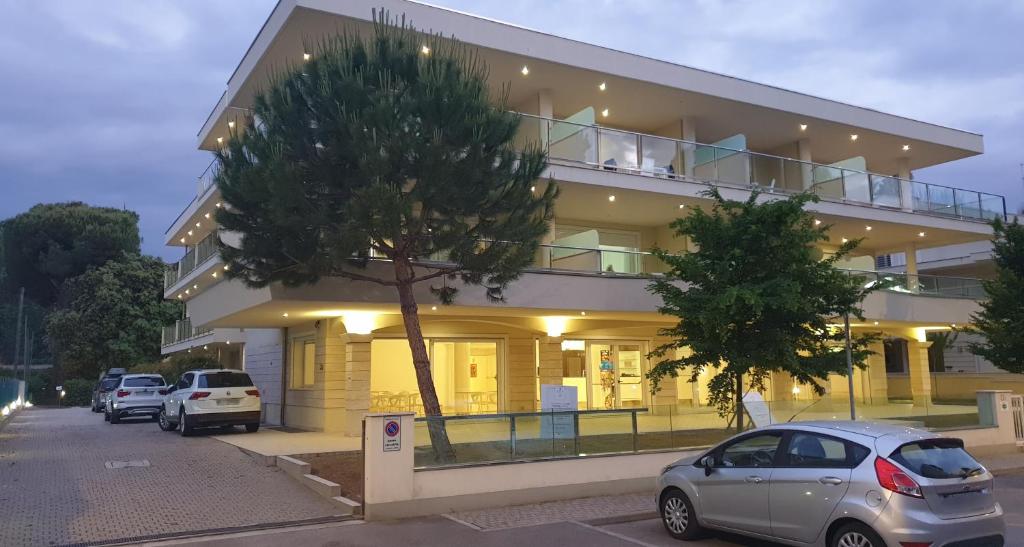 a building with cars parked in front of it at Residence I Diamanti in Cervia