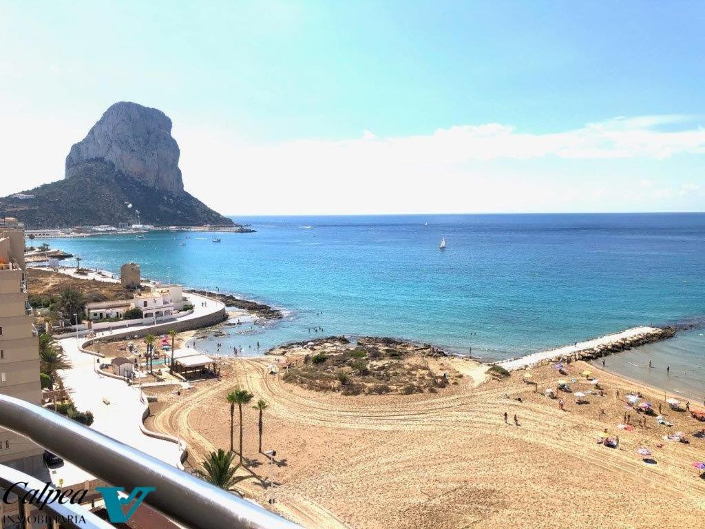 a view of a beach and the ocean at Porto Azul 10A Frontal Peñon & Sea View First Line Arenal Beach in Calpe