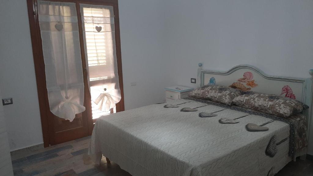 Postel nebo postele na pokoji v ubytování Appartamento Residence Mirice Vignola mare Aglientu casa Giorgia