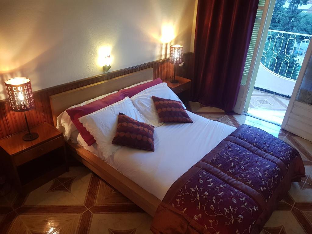 a bedroom with a bed with two pillows on it at Hotel el Hayat in Batna