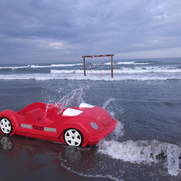 a toy car in the water on a beach at Nada SeaView Apartment in Shëngjin