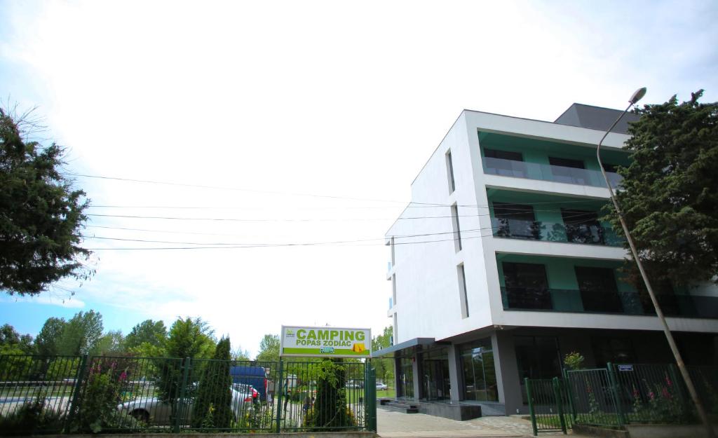 a white building with a sign in front of it at Popas Zodiac in Jupiter