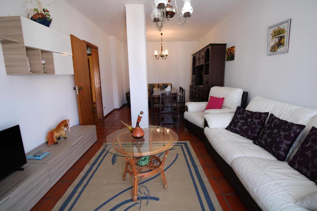 a living room with a couch and a table at Foz Beach House in Buarcos