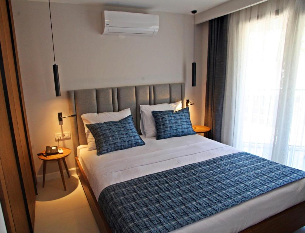 Postel nebo postele na pokoji v ubytování Queen Residences & Apart Hotel