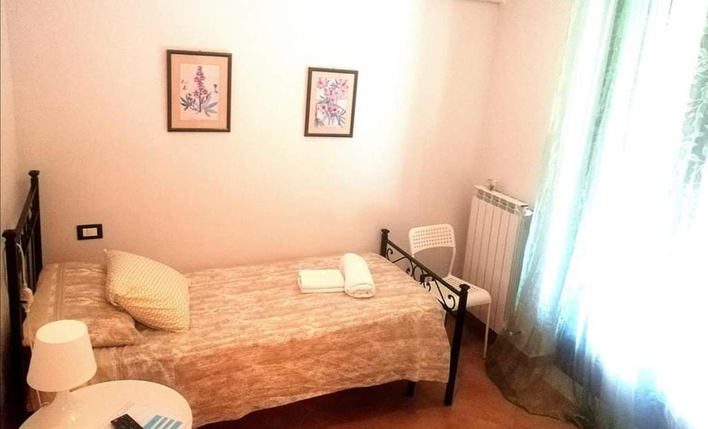 a small bedroom with a bed and a window at Villa Andrea B&B in San Silvestro