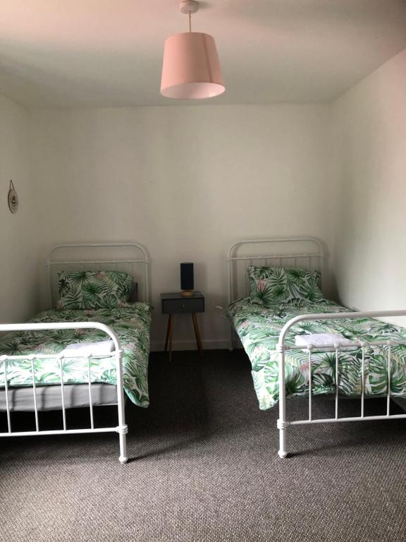 two beds sitting next to each other in a room at Llanberis Snowdonia in Llanberis