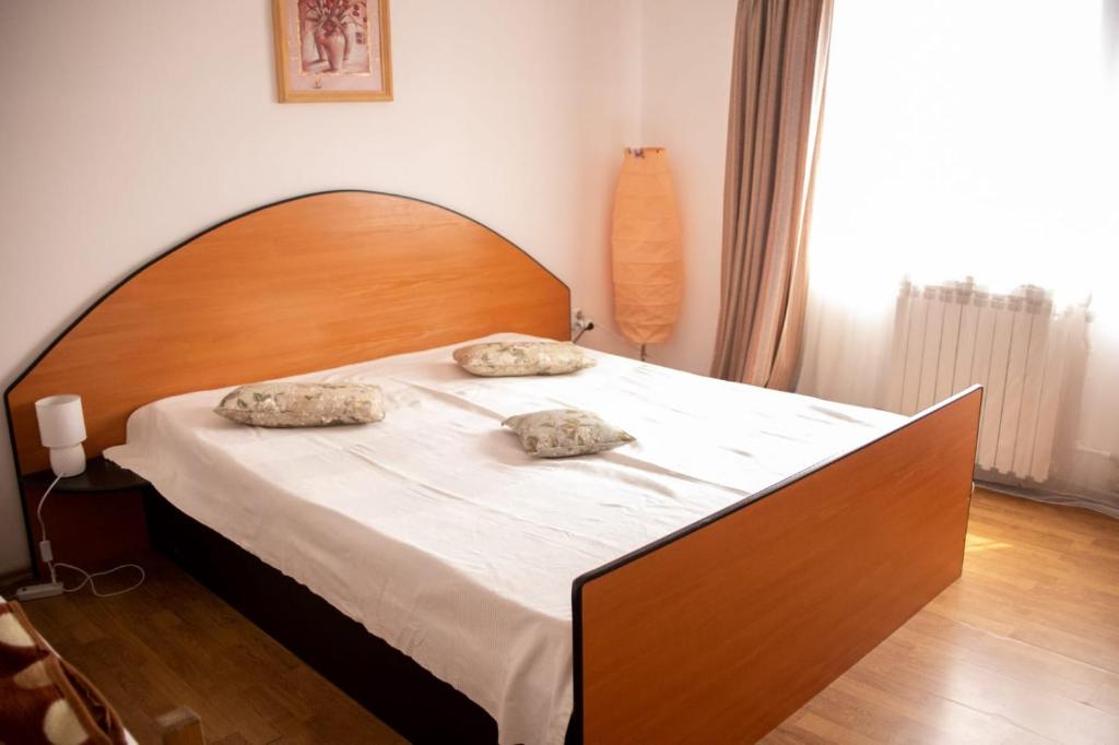a bed with two pillows on it in a bedroom at Sport Hostel Cluj in Cluj-Napoca