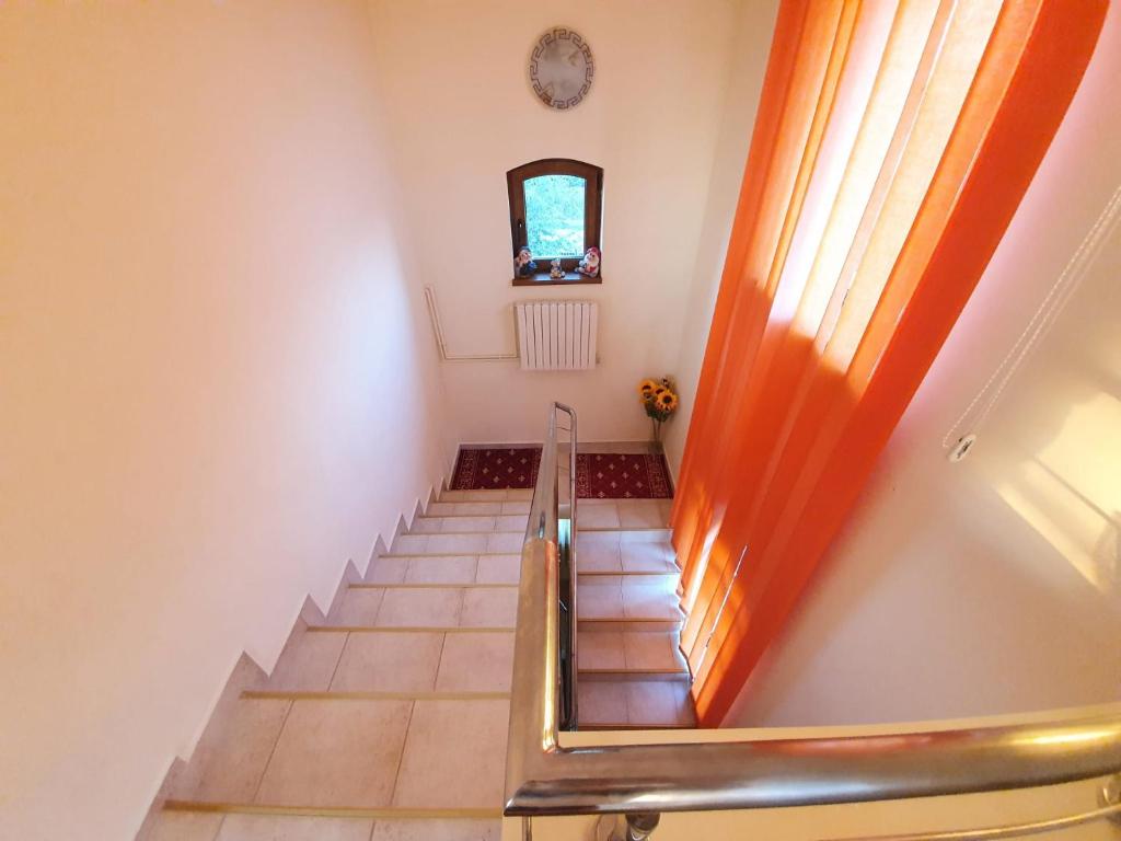 a staircase in a house with a window and a stair case at Villa Camelia in Tuzla