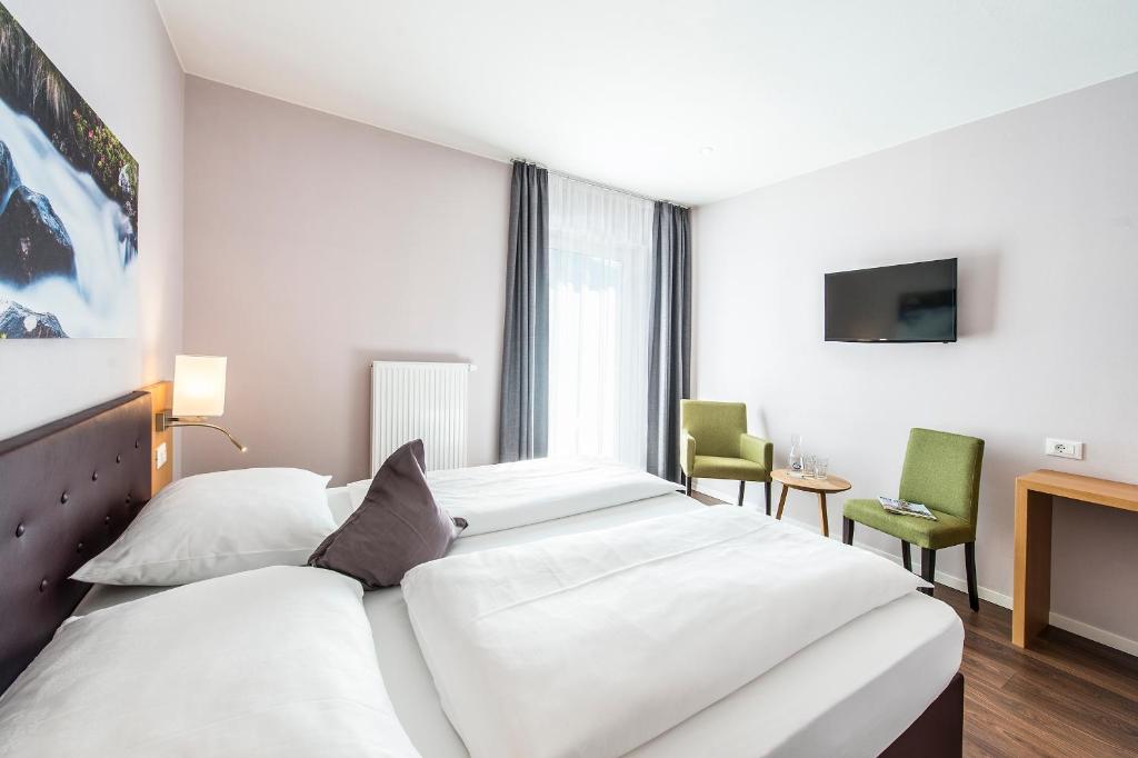 Postel nebo postele na pokoji v ubytování Hotel Jardis