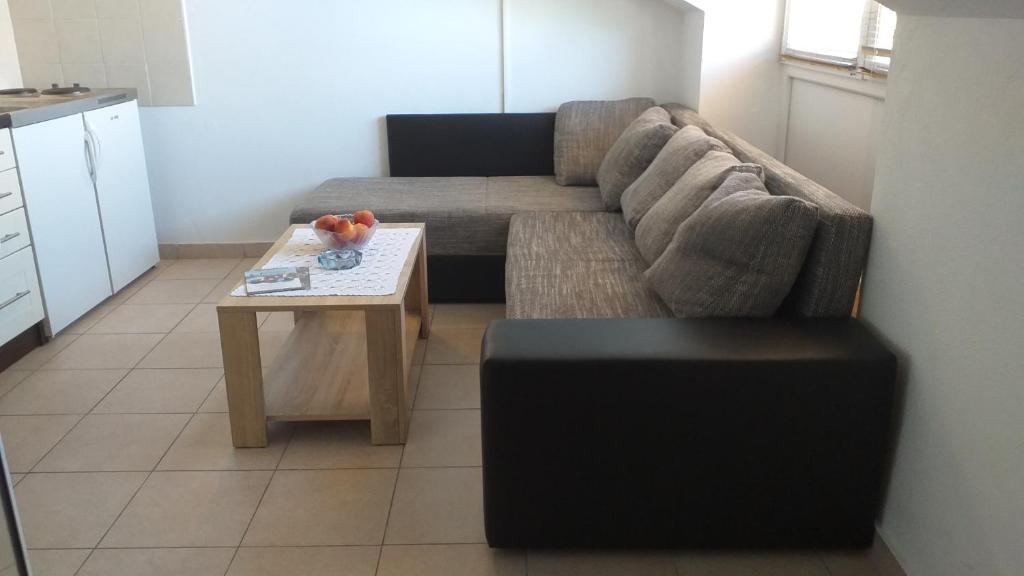 a living room with a couch and a coffee table at Lastovo City Center in Lastovo