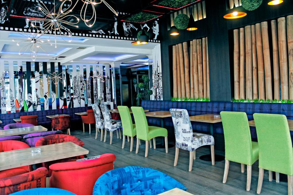 a restaurant with colorful chairs and tables in a room at ESTRADA Lux in Belgrade