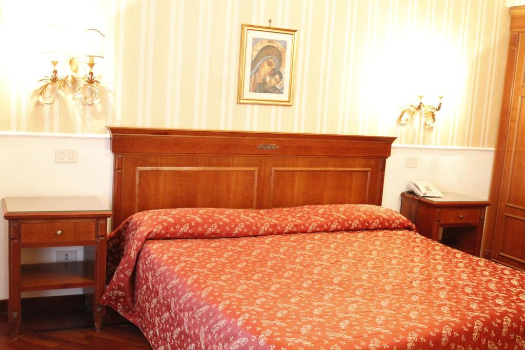 Postel nebo postele na pokoji v ubytování Hotel Torino