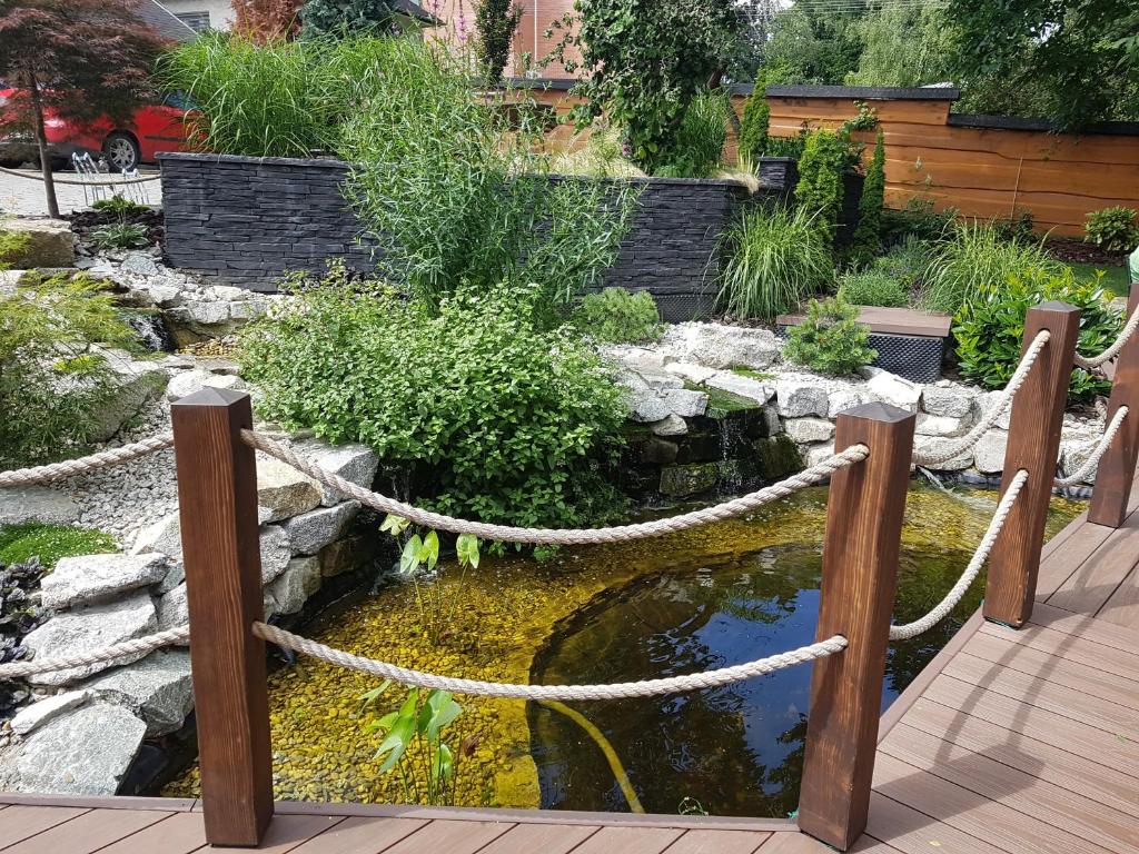 a fish pond with a rope around it at Apartman centrum v súkromí in Martin